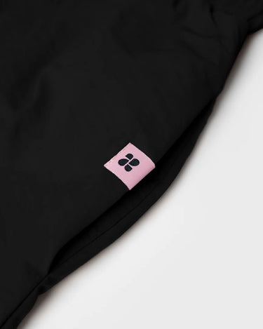 Black vegan skirt made from recycled materials with a small pink brand tag. - The New Orchard - Black / S