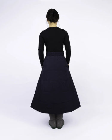 Navy blue A-line vegan skirt made from recycled materials, midi length, worn with black top and gray socks. - The New Orchard - Navy Blue / S