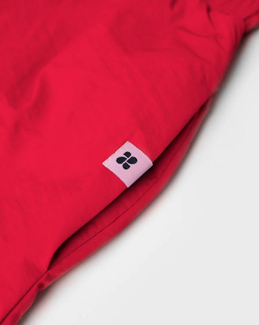 Red vegan skirt made from recycled materials with small black logo tag. - The New Orchard - Vivid Red / S