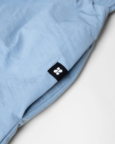 Sky blue winter vegan skirt made from recycled materials with black logo tag. - The New Orchard - Sky Blue / S