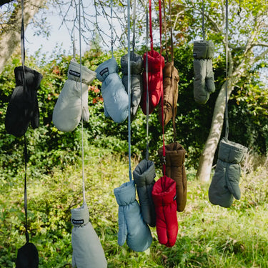 Navy blue vegan winter gloves made from recycled materials hanging outdoors on strings. - The New Orchard - ⁠Navy Blue