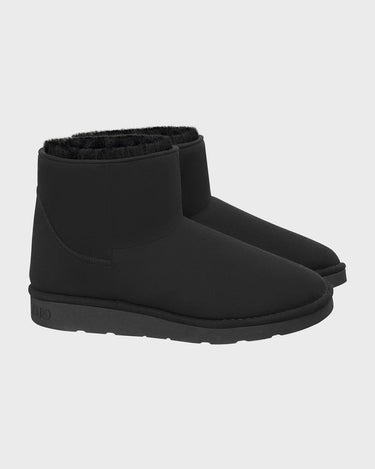 Pair of black ankle vegan boots on a light gray background
