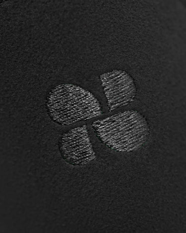 Close-up of a textured logo on a black background