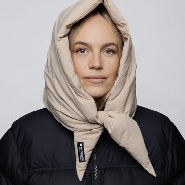Light beige vegan winter capuche made from recycled materials, styled over black puffer jacket. - The New Orchard - Light Beige