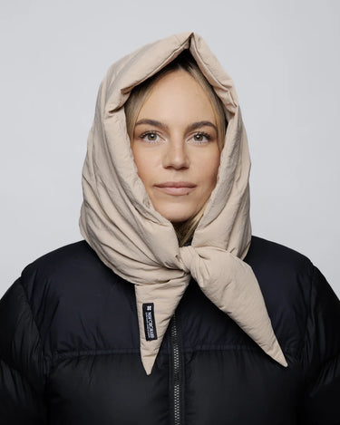 Light beige vegan winter capuche made from recycled materials, styled over black puffer jacket. - The New Orchard - Light Beige