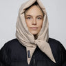 Light beige vegan winter capuche made from recycled materials, styled over black puffer jacket. - The New Orchard - Light Beige