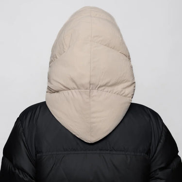Light beige vegan winter capuche made from recycled materials, shown from the back on a black puffer jacket. - The New Orchard - Light Beige