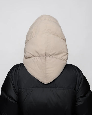 Light beige vegan winter capuche made from recycled materials, shown from the back on a black puffer jacket. - The New Orchard - Light Beige
