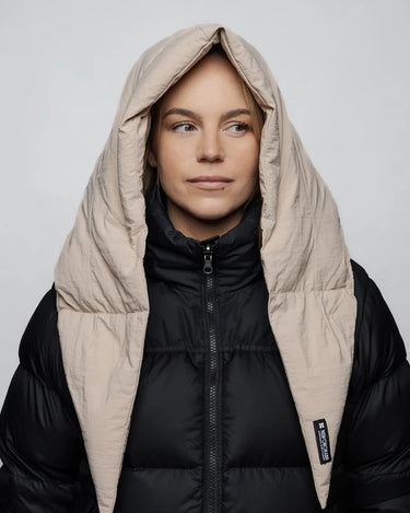 Light beige vegan puffer hood made from recycled materials, worn over black jacket. - The New Orchard - Light Beige