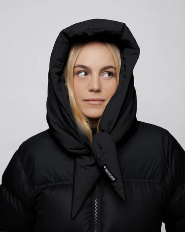 Black vegan puffer jacket with hood made from recycled materials, styled with hood up. - The New Orchard - Charcoal Black
