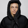 Black vegan puffer jacket with hood made from recycled materials, styled with hood up. - The New Orchard - Charcoal Black