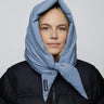 Sky blue vegan capuche made from recycled materials, styled over black puffer jacket. - The New Orchard - Sky Blue