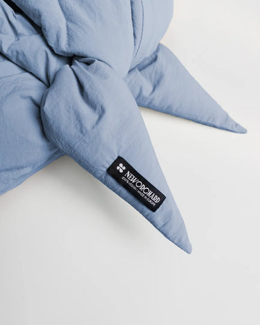 Sky blue vegan capuche made from quilted recycled materials with black logo patch. - The New Orchard - Sky Blue