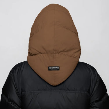 Warm brown vegan capuche made from recycled materials, shown from the back on a black puffer jacket. - The New Orchard - Warm Brown