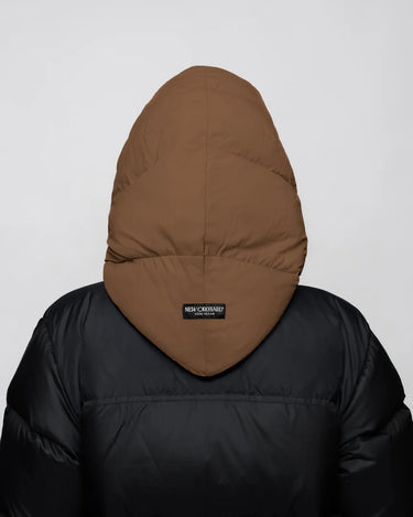 Warm brown vegan capuche made from recycled materials, shown from the back on a black puffer jacket. - The New Orchard - Warm Brown