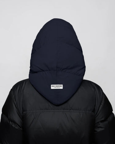 Navy blue vegan winter capuche made from recycled materials on black puffer jacket back view. - The New Orchard - ⁠Navy Blue