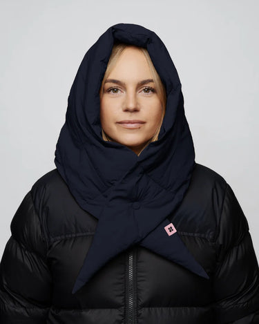 Navy blue vegan capuche made from recycled materials, worn over a black puffer jacket. - The New Orchard - ⁠Navy Blue