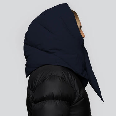Navy blue vegan puffer hood made from recycled materials, worn over black quilted jacket, side view. - The New Orchard - ⁠Navy Blue