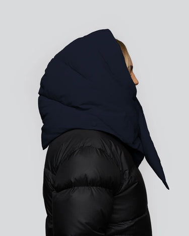 Navy blue vegan puffer hood made from recycled materials, worn over black quilted jacket, side view. - The New Orchard - ⁠Navy Blue