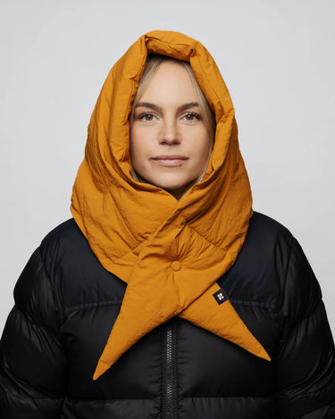 Amber yellow vegan winter capuche made from recycled materials, worn over black puffer jacket. - The New Orchard - Amber Yellow
