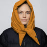 Amber yellow vegan hood made from recycled materials, styled over black puffer jacket. - The New Orchard - Amber Yellow