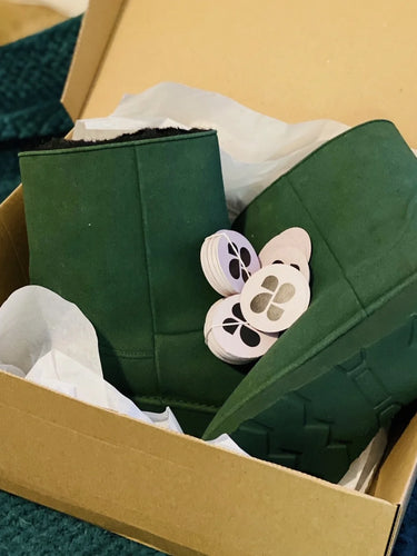 Vegan green shoes in a cardboard box