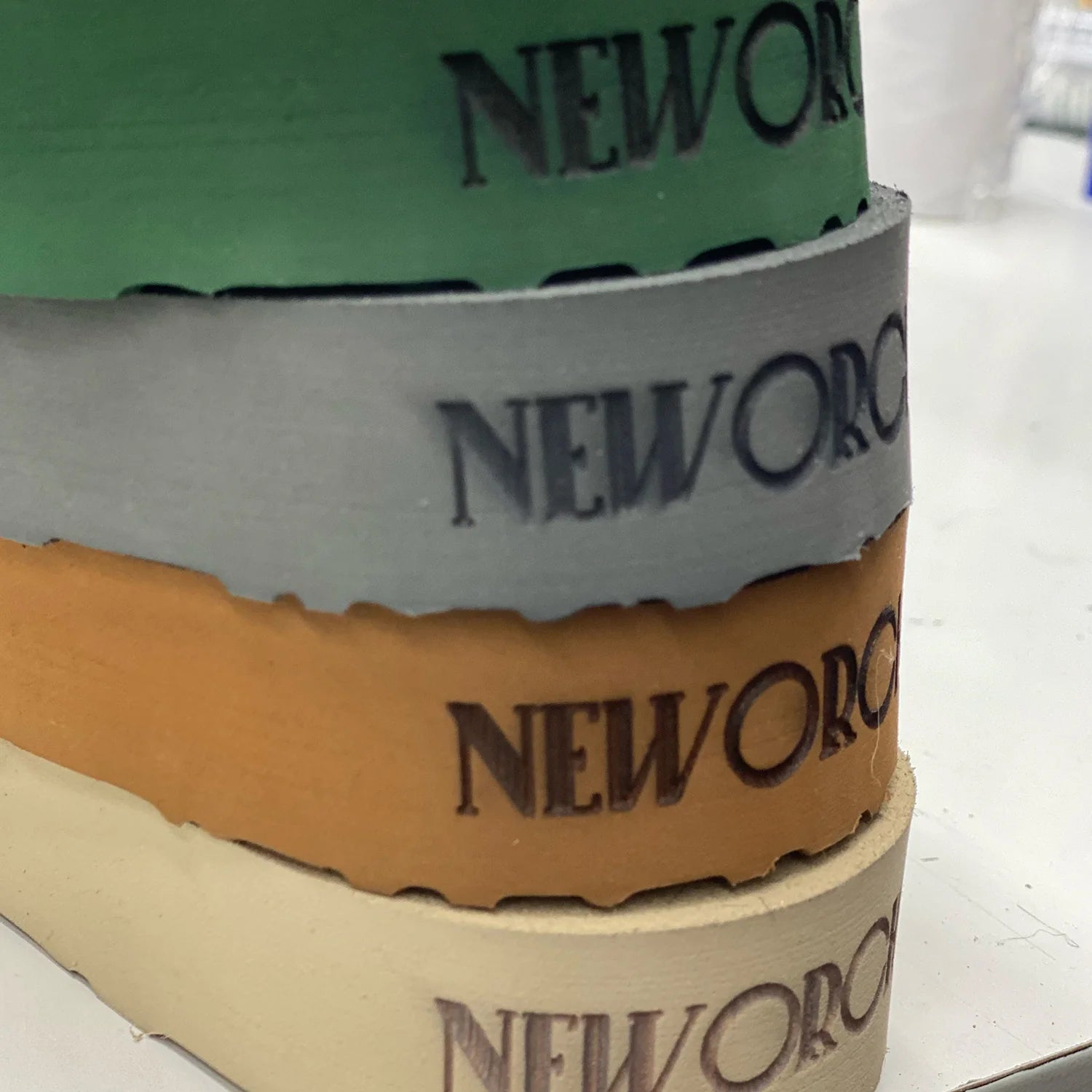 Stack of New Orchard shoes soles straps in different colors.