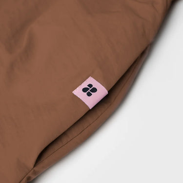 Brown vegan winter skirt with recycled materials tag and smooth fabric texture. - The New Orchard - Brown / S