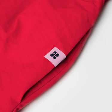 Red vegan skirt made from recycled materials with small black logo tag. - The New Orchard - Vivid Red / S